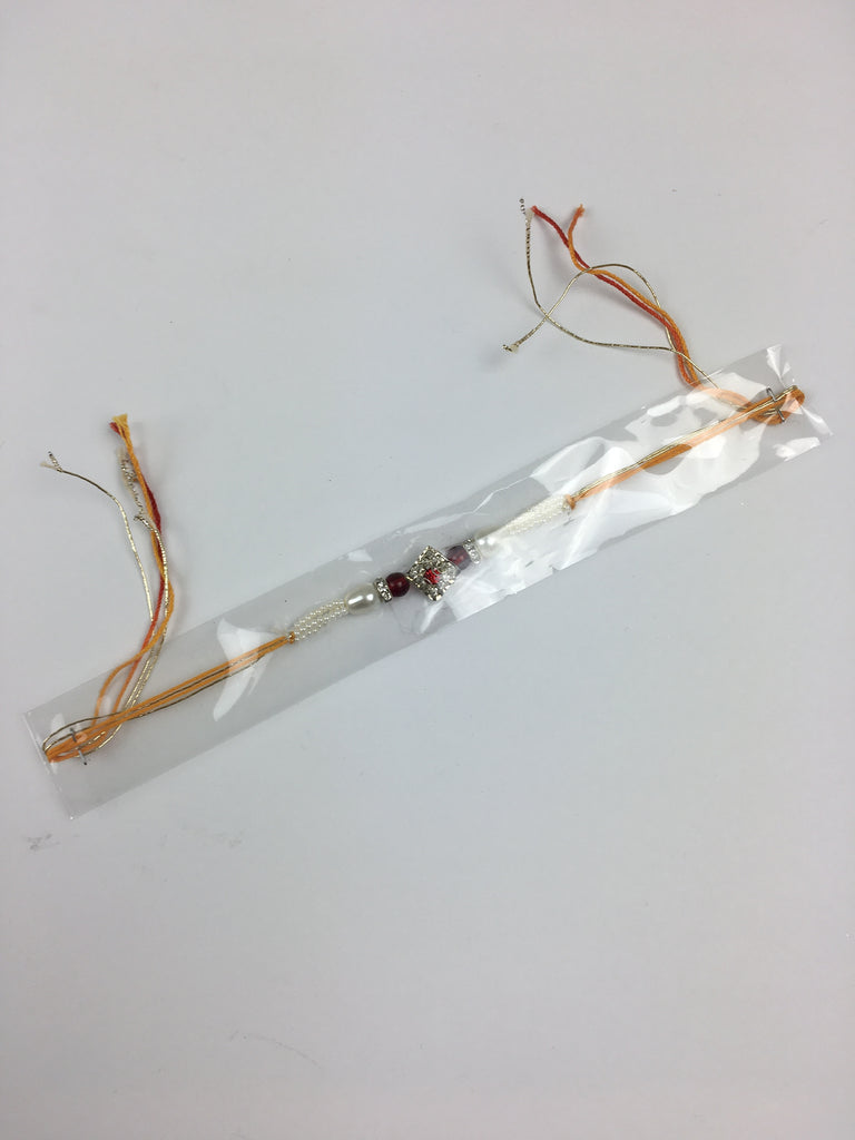 Single Diamond Shaped Crystal Rakhi With Central Red Stone And Pearls - R126
