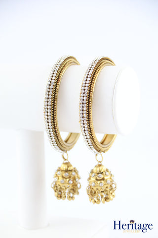 Intricately designed antique gold bangles adorned with crystals