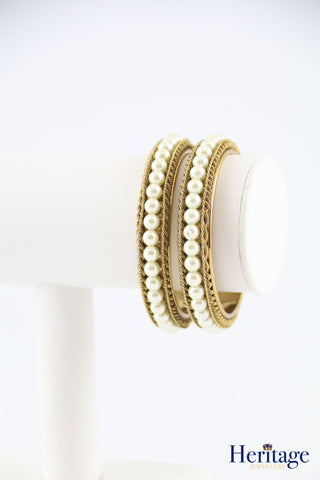 Intricately designed antique gold bangles adorned with crystals