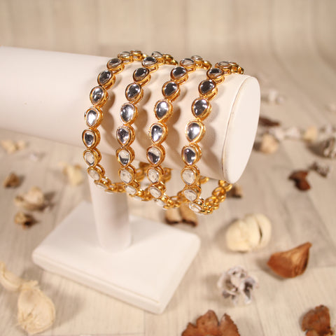 Intricately designed antique gold bangles adorned with crystals